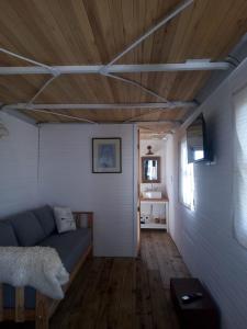 a living room with a couch and a wooden ceiling at Vittorio, en Llohue in Villa Ventana
