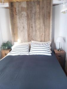 a bedroom with a large bed with striped pillows at Vittorio, en Llohue in Villa Ventana +25 photos