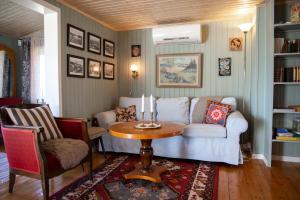 a living room with a couch and a table at Almas gård in Ullared