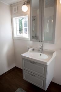 a white bathroom with a sink and a window at Almas gård in Ullared +43 photos