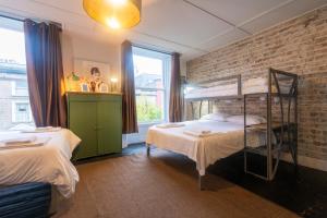 a bedroom with two bunk beds and a brick wall at Georgian Loft Apartment in Dublin