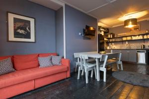 a living room with a red couch and a table at Georgian Loft Apartment in Dublin