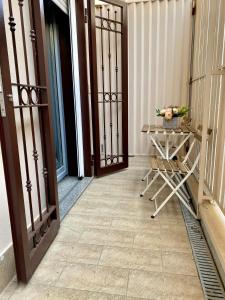 a room with a door and a table with flowers at San Marzano Rooms in San Marzano sul Sarno +3 photos