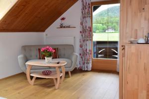 a living room with a couch and a table at Pension Hohenau in Fuschl am See