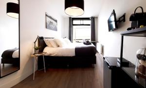 a bedroom with a bed and a window and a mirror at Modern Hideout Ace Location in Amsterdam