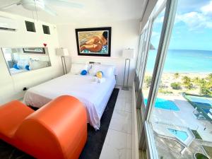 a bedroom with a bed and a view of the ocean at Ocean View apt on Isla Verde in a 14th floor in San Juan