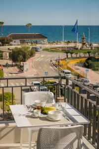 a table on a balcony with a view of the ocean at Sunny modern Apartment Perfect located in Estepona