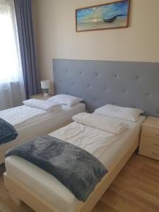 Posteľ alebo postele v izbe v ubytovaní Apartament na Wydmie Ustka