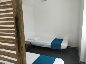 Postel nebo postele na pokoji v ubytování Gîte Les Pieds dans l'Olt - Ultreïa