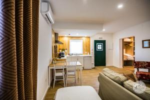 a living room with a couch and a table at Olívale - Turismo Rural in Campo Maior