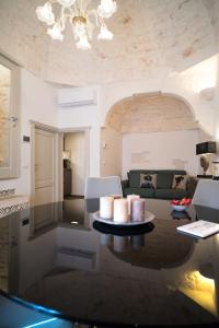 a living room with a couch and a table at 800s Home Luxury Rooms in Ostuni