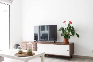 salon z telewizorem i stołem w obiekcie Apartamento Aguaviva, tu lugar al lado del Océano w Costa Teguise