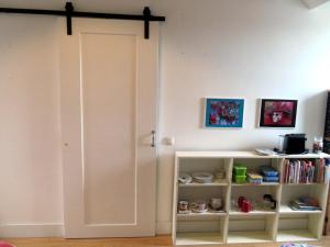 a room with a white door and a book shelf at Jacky's place in Helmond