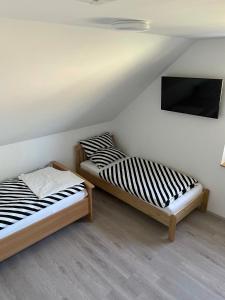 Postel nebo postele na pokoji v ubytování Jahn Apartments