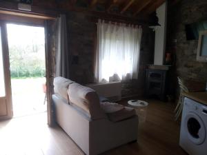 a living room with a couch and a window at Casa Miguel in Olea