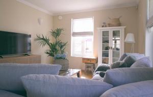 a living room with two couches and a tv at Linnuse Apartement in Haapsalu