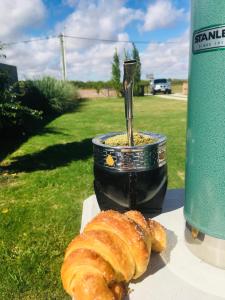 a loaf of bread sitting on a table next to a drink at Hospedaje “ El Segoviano “ in Carmelo