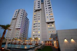 two tall buildings with a pool in front of them at Olympic Residence Deluxe Apartments in Limassol