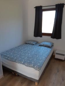 a bed in a room with a window at Choczewski Zakątek in Choczewo