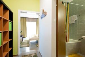 a bathroom with a walk in shower and a tub at Sportland Inn in Unterpeischlach +32 photos