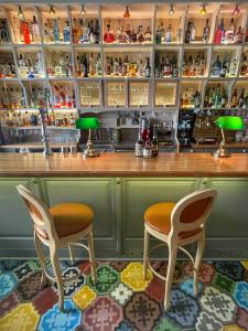 a bar with two chairs and a counter at Puppet rooms in Corfu +17 photos