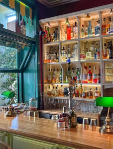 a bar with a lot of bottles of alcohol at Puppet rooms in Corfu