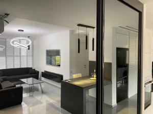 a living room with a couch and a table at New! luxus- Best suit 2 minutes fromTel Aviv in Bat Yam