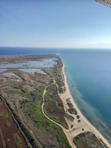 an aerial view of a road next to the ocean at GERANI apartments in Órmos