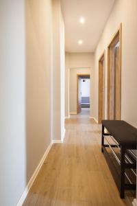 a hallway with a wooden floor and a table at Royal Aparthotel Piotrkowska 33 in Łódź