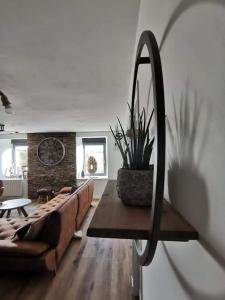 a living room with a couch and a mirror at Loft 100m2 neuf entièrement équipée in Callac