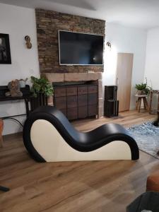 a living room with a black and white couch at Loft 100m2 neuf entièrement équipée in Callac