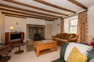 a living room with a couch and a fireplace at Fairleas Farm in Durham