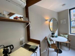 a small room with a table and a mirror at Houseboat Sophia in Amsterdam +9 photos