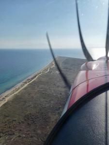 a view of an island from the window of an airplane at GERANI apartments in Órmos
