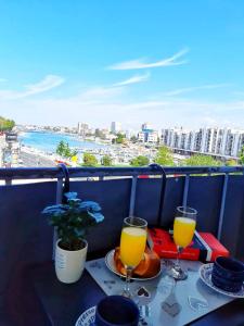 a table with two glasses of orange juice on a balcony at Apartment Ana & Marko in Zadar