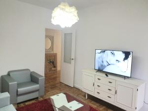 a living room with a flat screen tv on a dresser at CONTRASTES RIBEIRA SACRA in Monforte de Lemos