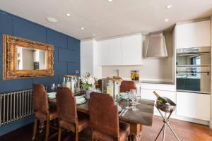 a kitchen with a dining room table with chairs at Exceptional, boutique retreat Bath road Cheltenham in Cheltenham