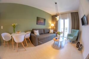 a living room with a couch and a table at Kassiopi Luxury Suites in Kassiopi