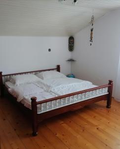 a bed sitting on a wooden floor in a room at at Marian's place in Spuhlja