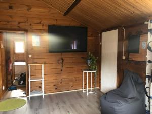 a living room with a flat screen tv on a wall at Three Rooms stuga i stugby near National Park in Undenäs