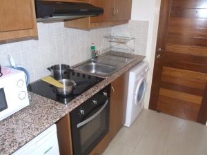 a kitchen with a sink and a stove and a dishwasher at Pleasant Studio apartment, Z4 in Vanessa Complex in Peyia