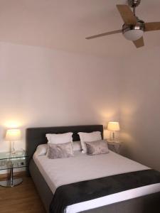 a bedroom with a large bed with two pillows at Sevilla Aljarafe Room in Bormujos