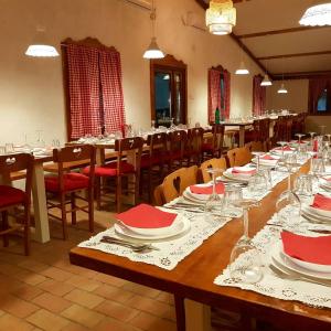 a dining room with tables and chairs with red napkins at Domacinstvo Cikic Zasavica in Zasavica