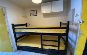 a couple of bunk beds in a small room at ARGELES PLAGE STUDIO PISCINE PARK. PRIVATIF DANS RES. SECURISEE in Argelès-sur-Mer