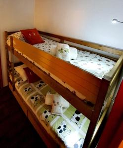 a wooden bunk bed with cows on it at La Riviere Vue Mont Blanc in Chamonix