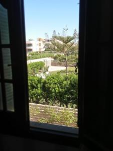 a window view of a park from a building at suite 1 f3 or f4 villa114 2beds garden viwe Green Beach in El Alamein