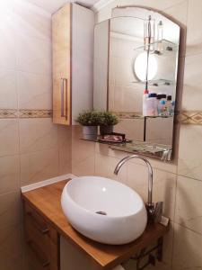 a bathroom with a white sink and a mirror at Holiday Home Kotulin in Pakoštane +24 photos