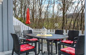 a patio with a table and chairs and an umbrella at 3 Bedroom Cozy Home In Extertal in Extertal
