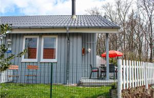 a small house with a table and a fence at 3 Bedroom Cozy Home In Extertal in Extertal +17 photos