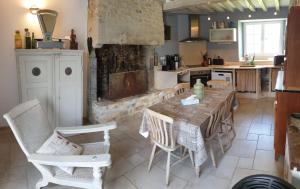 a kitchen with a table and chairs in a kitchen at Normandieheritage14 COTTAGE DU MARAIS OMAHA BEACH DDAY Tour guide E-bike Hiking in Canchy